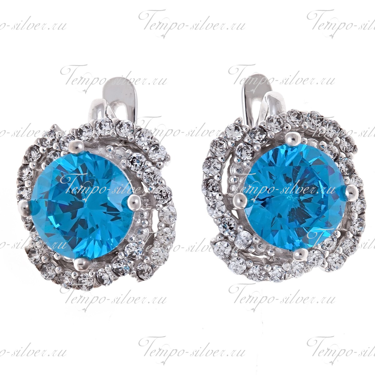 Серьги из серебра с крупным голубым камнем в центре композиции в форме цветка 