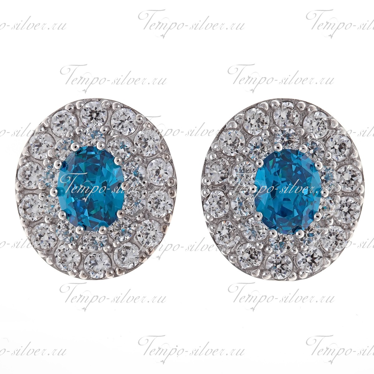 Серьги-гвоздики из серебра с овальным голубым камнем, окруженный двумя рядами белых камней